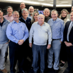 Bill Brown Ford in Livonia, MI, Sales Team posing for the second title as the World's #1 Ford Dealership for Sales Volume in 2022