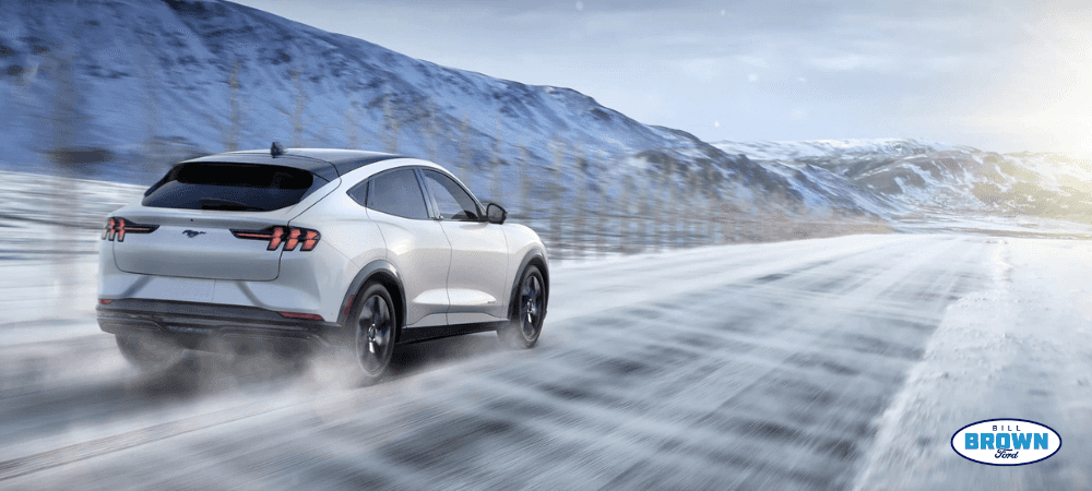 2023 Electric Mach-E driving down a snowy road in Michigan from Bill Brown Ford