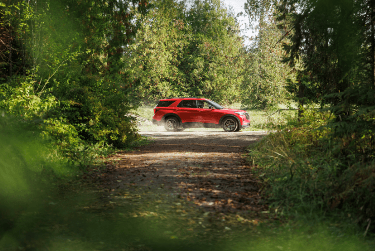 Red 2025 Ford Explorer parked in the woods