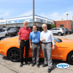 Bill Brown Ford's Pre-Owned Sales staff in front of a Mustang