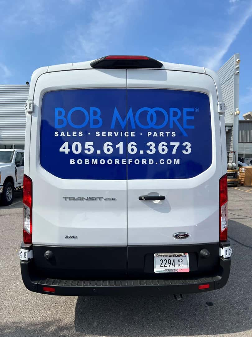 Ford Pro Transit van back window advertising: "Ford Mobile Service in OKC. Call 405-616-3673" 