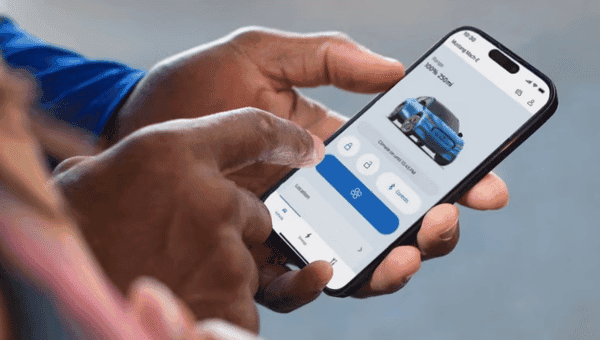 Person using a mobile app on a smartphone to control the features of a Mustang Mach-E, with options to lock, unlock, and access climate controls. 