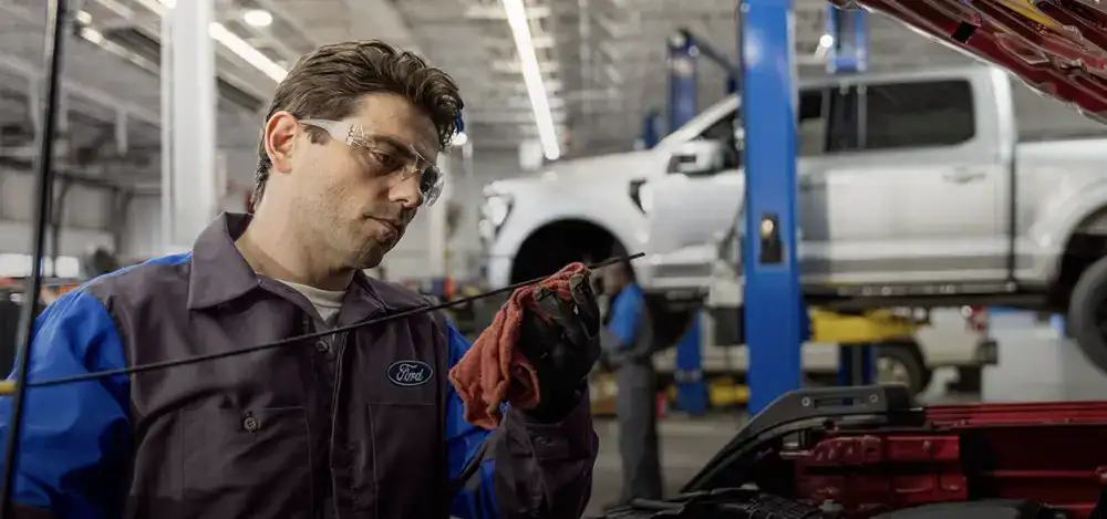 Ford technician performing an oil change at Bowen Scarff Ford in Kent, WA