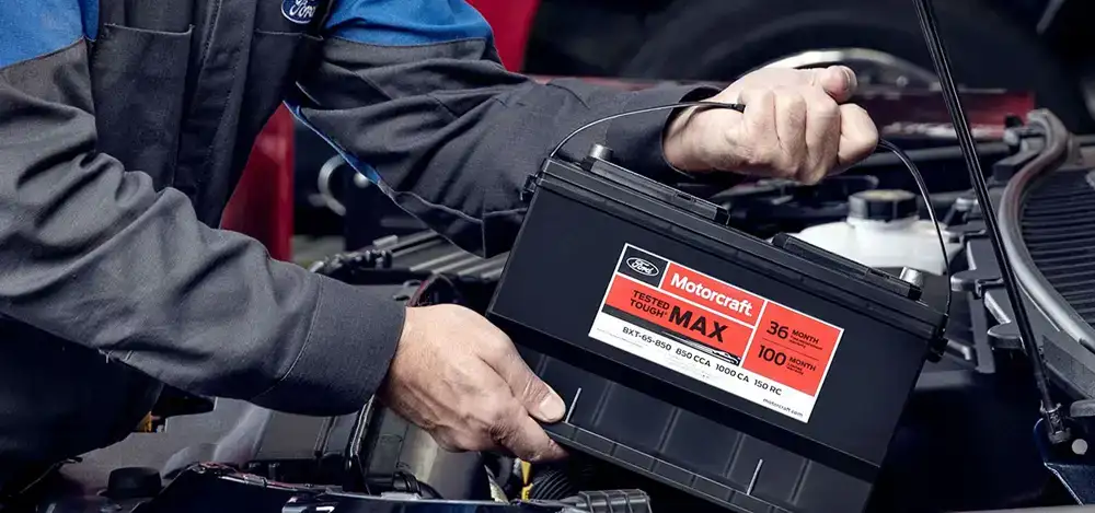Ford technician testing a car battery at Bowen Scarff Ford in Kent, WA
