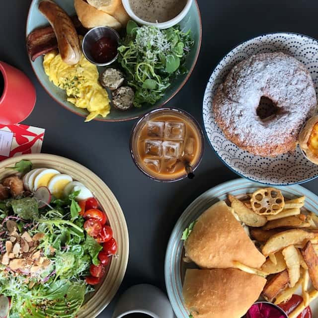 Sliced vegetables and bread on stainless steel round tray