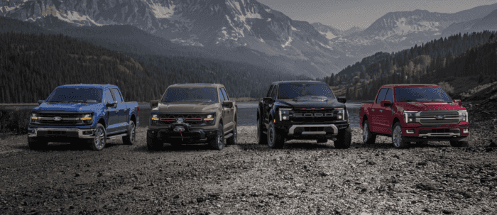 2025 Ford F-150 truck models parked in front of lake