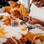 Mother and daughter make autumn decoration at home