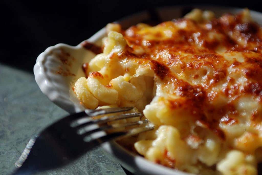 baked mac and cheese with a fork by the bowl