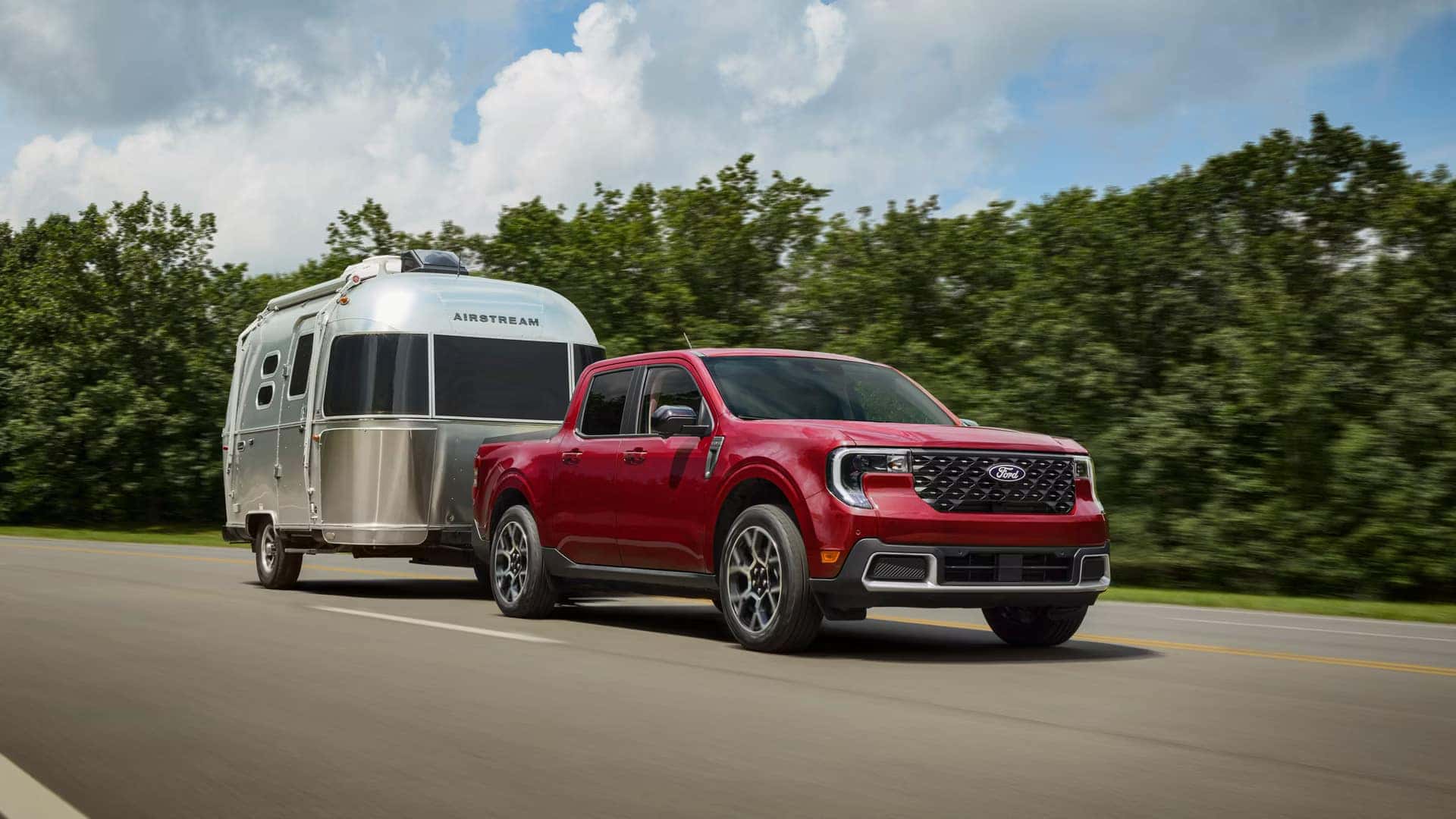 a new 2026 ford maverick towing a small air stream camper