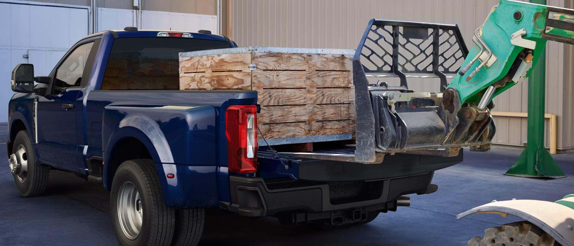 an exterior view of the new 2026 ford super duty truck bed being used to haul heavy crates