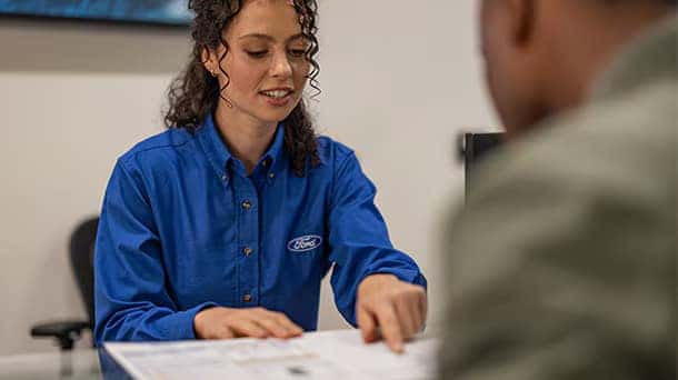a ford service member and a customer setting up a maintenance schedule