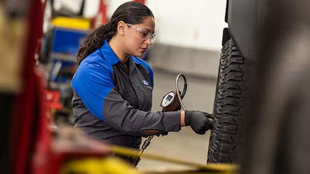 a ford service member looking a air pressure in tires