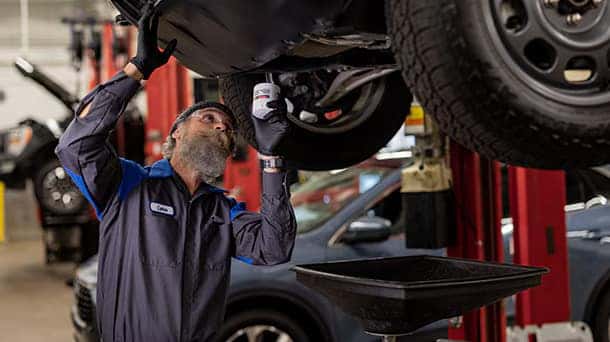 a ford service member performing a fluid service change