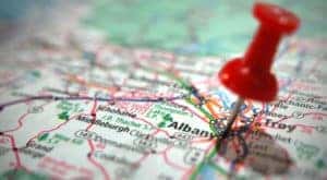 Red pin poked into Albany NY on a green a white map after searching ''Ford dealership, Albany, NY.''