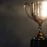 Gold, glowing trophy against a black background