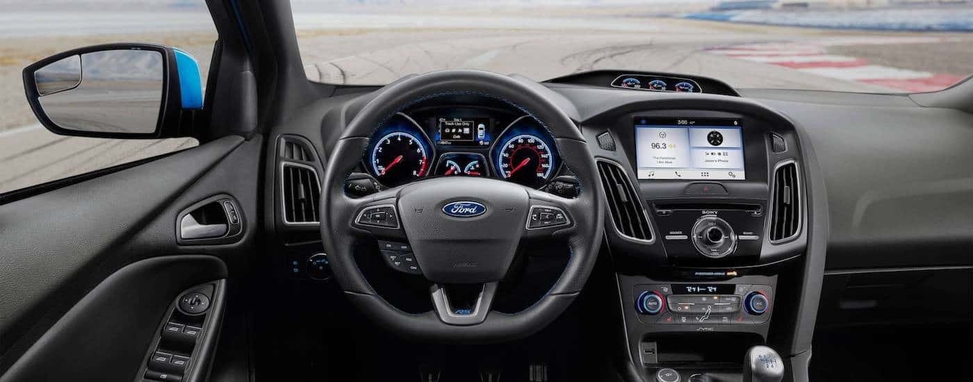 The dashboard of a 2017 Ford Focus is shown with a race track in the window near Albany, NY.