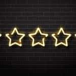Five LED stars on a black brick wall