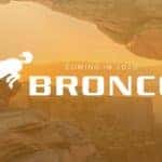 white Ford Bronco logo over a picture of a canyon with a sunset