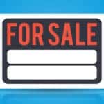 Black, white, and orange "FOR SALE" sign on a blue background