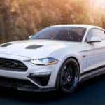 A white 2019 Roush Mustang is driving on a highway near Albany, NY, headed to one of the best Ford dealership locations.