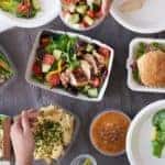 Multiple containers of healthy take out food is shown from above from an Albany, NY restaurant.