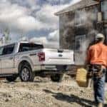 Construction workers are walking toward a silver 2020 Ford F-150 at a work site near Albany, NY.