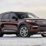A burgundy 2021 Ford Explorer Platinum is parked on snow.