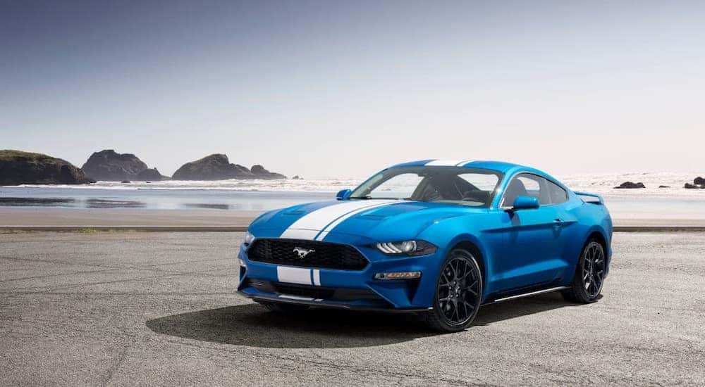 A blue 2020 Ford Mustang is parked on a beach. after the owner searched ''Roush''.