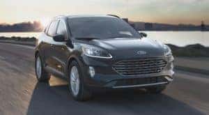 A gray 2021 Ford Escape is driving next to a river after leaving an Albany Ford Escape dealership.