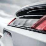 A row of mustangs is shown from the rear at a NY certified pre-owned Ford dealer.