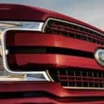 A close up shows the grille and headlight on a 2020 Ford F-150.