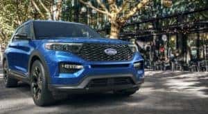 A blue 2021 Ford Explorer is shown from the front parked outside of a restaurant after leaving a Ford Explorer ST dealer.