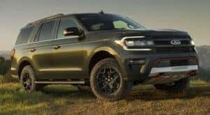A green 2022 Ford Expedition is shown from the side parked in a field after finding the best Ford pre-order dealer.