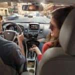 A couple is shown leaving a NY CPO Ford dealer in a 2017 Ford Fiesta.