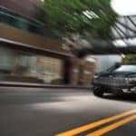A black 2020 Ford Fusion Energi Titanium is shown speeding down a street.