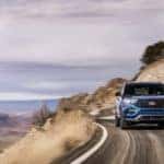 A dark blue 2020 Ford Explorer ST is shown driving on a winding road after visiting a Schenectady used Ford dealer.