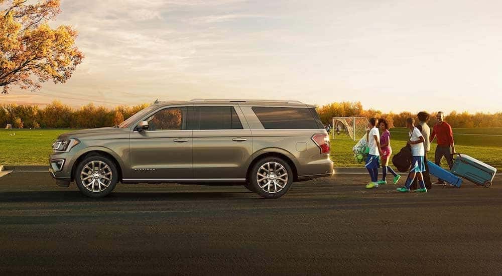 A tan 2018 Ford Expedition Platinum is shown from the side after a youth soccer game.