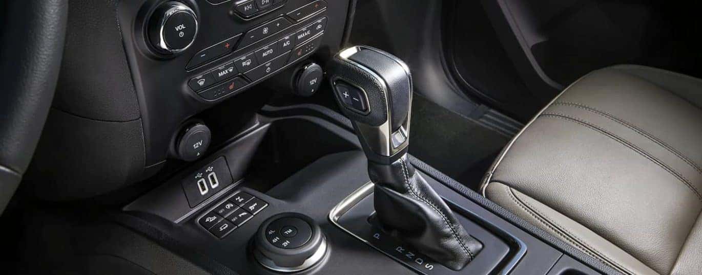 The black and grey interior of a 2022 Ford Ranger Lariat shows the center console.