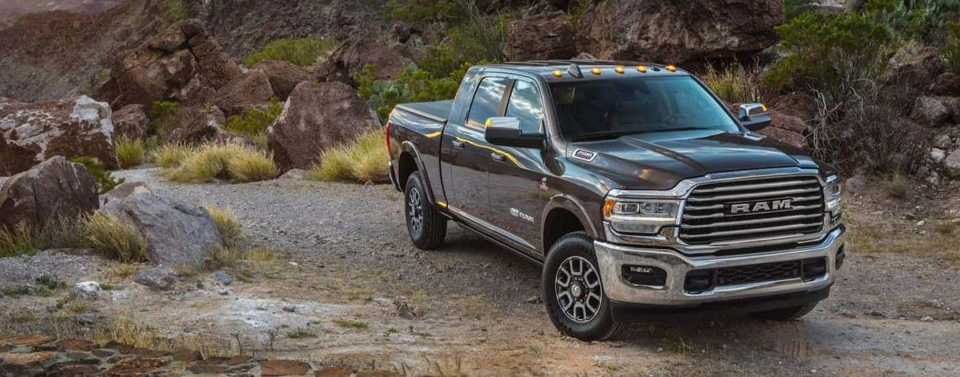 A grey 2022 Ram 1500 Limited Longhorn is shown parked on gravel.