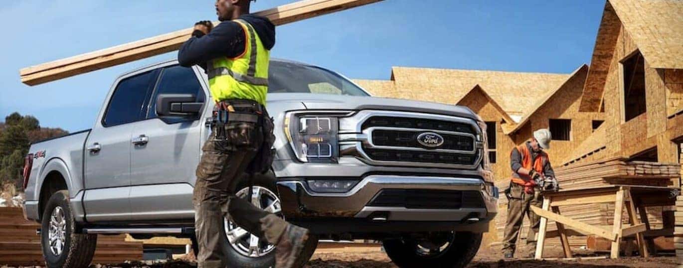 A silver 2022 Ford F-150 XLT is shown at a construction site.