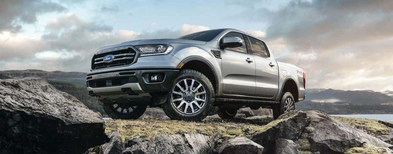 A silver 2022 Ford Ranger is shown off-roading during a 2022 Ford Ranger vs 2022 Nissan Frontier comparison.