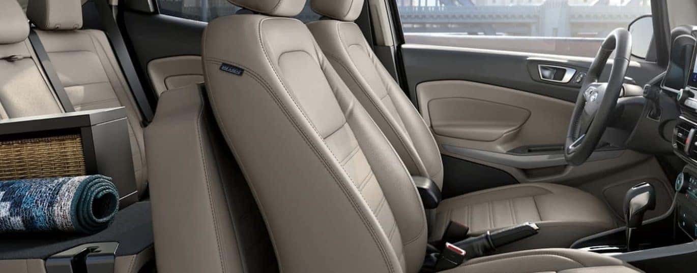 The tan interior of a 2022 Ford EcoSport shows two rows of seating.