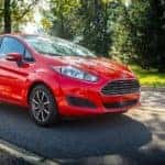 A red 2015 Ford Fiesta is shown from the front at an angle after leaving a Ravena used Ford dealer.