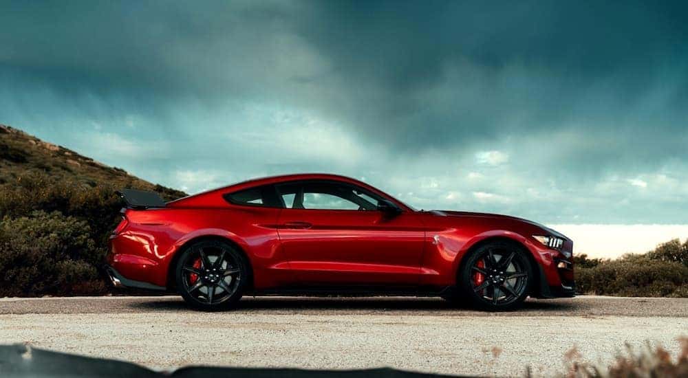A red 2020 Ford Mustang Shelby GT 500 is shown from the side parked.