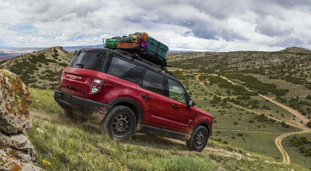 A red 2021 Ford Bronco Sport is shown from the side off-roading.