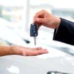 Someone is shown handing over their keys after they decided 'I need to sell my car'.