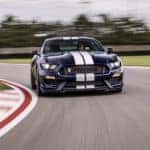 A popular Certified Pre-Owned Ford, a dark blue 2019 Ford Mustang GT350, is shown on a race track.