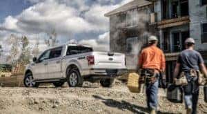 A silver 2020 Ford F-150 is shown from behind on a construction site.