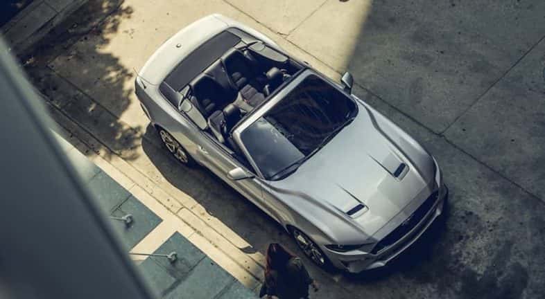 A silver 2020 Ford Mustang convertible is shown from a high angle after leaving a Albany used Ford dealer.