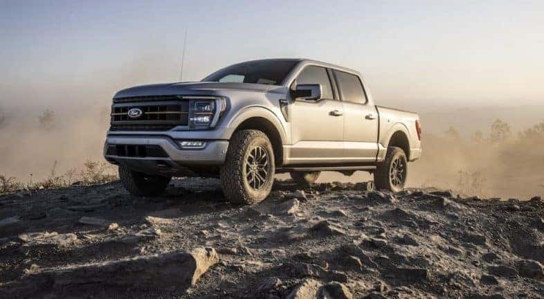 A silver 2022 Ford F-150 Tremor is shown from the front at an angle while parked off-road.